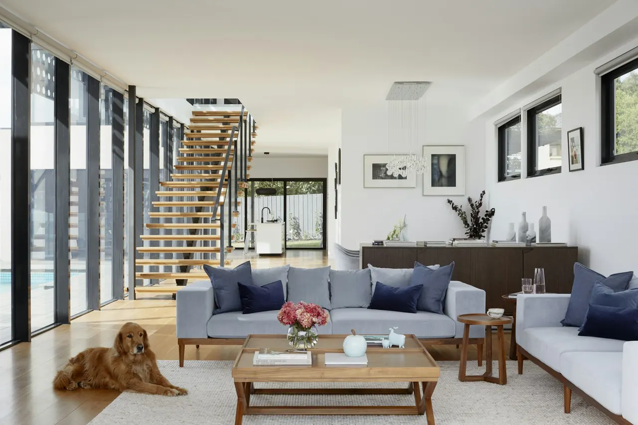 Open-plan living room with new open-riser stairs and large windows
